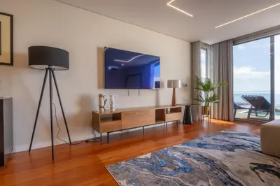 a living room with a flat screen tv on the wall at Tiz house in Funchal