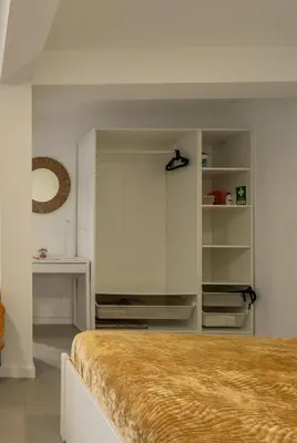 a bedroom with a bed and white walls at Sun Hill Apartment in Santa Cruz