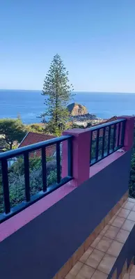 a balcony of a house with a view of the ocean at De Freitas Home by Rent-a-key in Porto Moniz