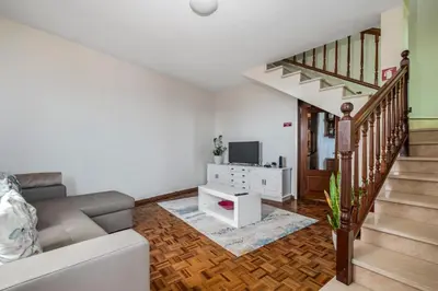 a living room with a couch and a television at De Freitas Home by Rent-a-key in Porto Moniz