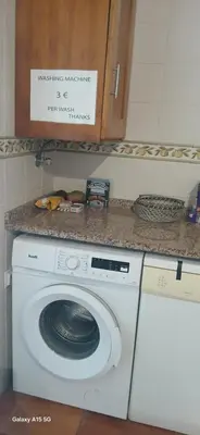 a washing machine in a kitchen with a counter at ARTIST HOUSE Rooms With View And Shared Kitchen in Arco da Calheta