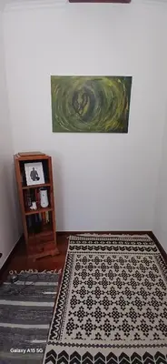 a room with a rug and a painting on the wall at ARTIST HOUSE Rooms With View And Shared Kitchen in Arco da Calheta