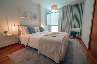 a bedroom with a large bed and a window at Kora Home in Santa Cruz