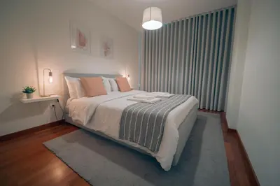 a bedroom with a large bed with pillows on it at Kora Home in Santa Cruz