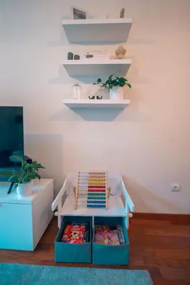 a room with a table with shelves on the wall at Kora Home in Santa Cruz