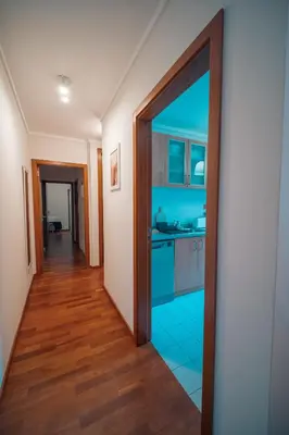 a hallway with a door leading into a kitchen at Kora Home in Santa Cruz