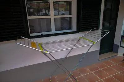 a metal bench sitting on top of a porch at Rita's house in Ponta Delgada