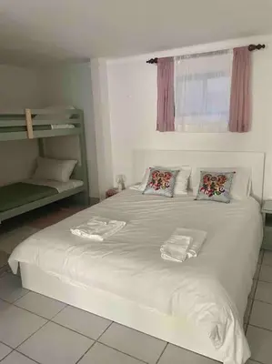 a white bed with two pillows on top of it at Ocean Breeze & Sea Salt Apartment in Luz