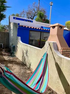 a hammock sitting in front of a building at Ocean Breeze & Sea Salt Apartment in Luz