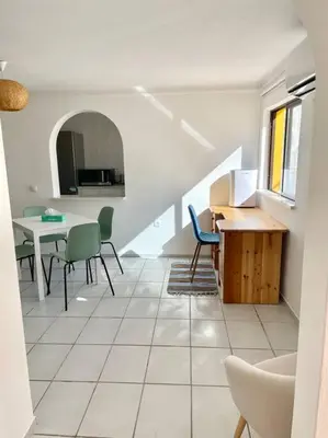 a living room with a table and chairs at Ocean Breeze & Sea Salt Apartment in Luz