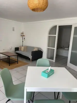 a living room with a white table and chairs at Ocean Breeze & Sea Salt Apartment in Luz