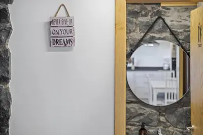 a mirror on a wall with a sign on it at Mountain Retreat by Homie in Porto Moniz
