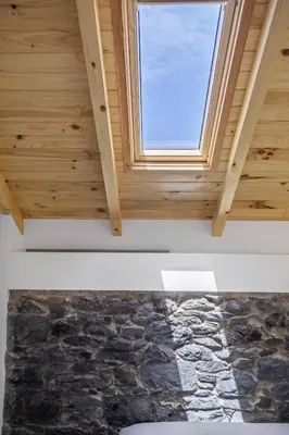 a room with a window and a stone wall at Mountain Retreat by Homie in Porto Moniz