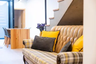 a couch with yellow pillows on it in a room at Casa Da Avó Clementina Nº 30 in Funchal
