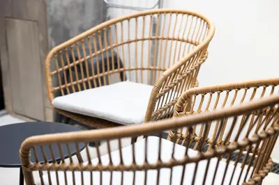 a wicker chair with a cushion on a table at Casa Da Avó Clementina Nº 30 in Funchal