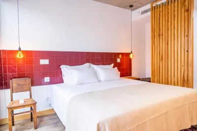 a bedroom with a large bed and a chair at Casa Da Avó Clementina Nº 30 in Funchal