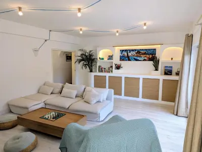a living room with a couch and a coffee table at Casa KIWI 3 chambres et piscine in Luz