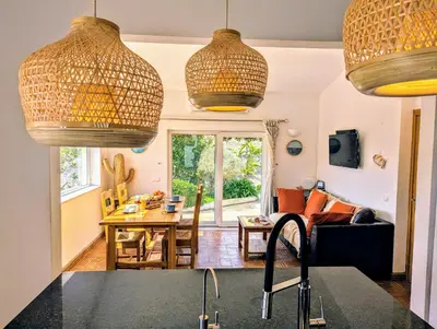 a kitchen with baskets hanging from the ceiling at Casa KIWI 3 chambres et piscine in Luz