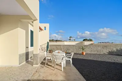 a patio with a table and chairs on a house at Casa Yucca - Porto Santo Island in Porto Santo