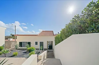 a white house with a white fence and trees at Casa Yucca - Porto Santo Island in Porto Santo