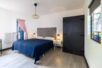 a bedroom with a bed with a blue bedspread at Panoramic House in Ribeira Brava