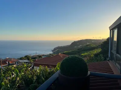 a view of the ocean from the balcony of a house at Panoramic House in Ribeira Brava