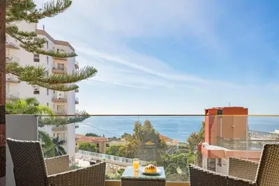 a balcony with chairs and a view of the ocean at Casa das Raposinhas I in Funchal