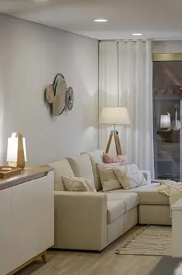 a living room with a white couch and a lamp at Casa das Raposinhas II in Funchal