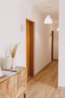 a living room with white walls and wooden floors at Pure Flor de Esteva in Vila do Bispo