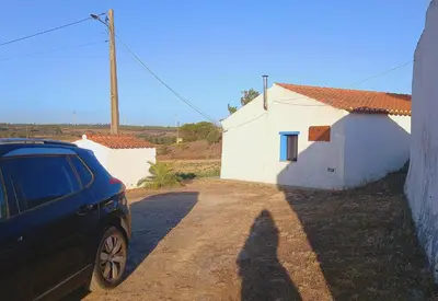 a shadow of a person standing in front of a house at Charme Rústico in Aljezur