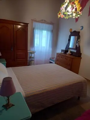a bedroom with a bed and a dresser and a mirror at Charme Rústico in Aljezur