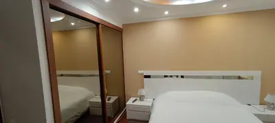 a small bedroom with a bed and a mirror at Reis Magos Beach Caniço Sea line Apartment in Caniço