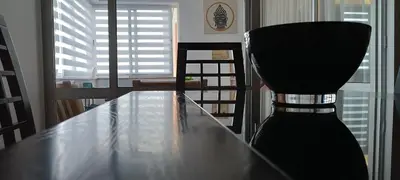 a wooden table in a room with a window at Reis Magos Beach Caniço Sea line Apartment in Caniço