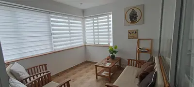 a living room with two windows and a couch at Reis Magos Beach Caniço Sea line Apartment in Caniço
