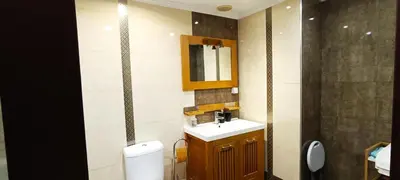 a bathroom with a sink and a mirror and a toilet at Reis Magos Beach Caniço Sea line Apartment in Caniço