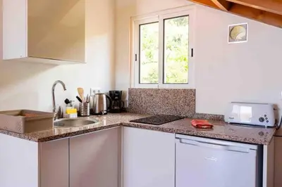 a kitchen with white cabinets and a sink and a window at Apartment 1BR Hills over Ponta do Sol, sea view in Ponta do Sol