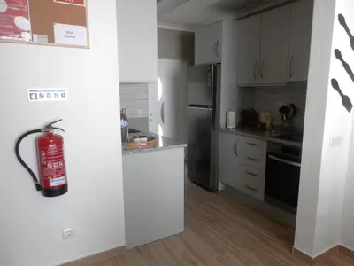 a kitchen with a fire extinguisher hanging on the wall at Casa Baptista in Vila do Bispo