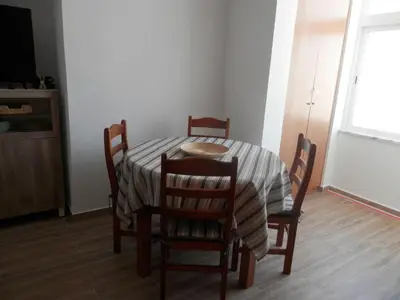 a dining room table and chairs with a table and a window at Casa Baptista in Vila do Bispo