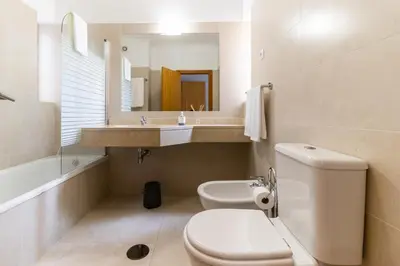 a bathroom with a toilet and a sink and a mirror at Ocean View Flat in Câmara de Lobos