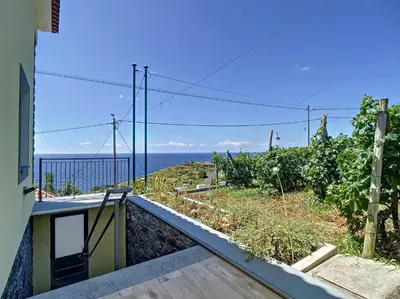 a view of the ocean from the balcony of a house at My School I by Atlantic Holiday in Ponta Delgada