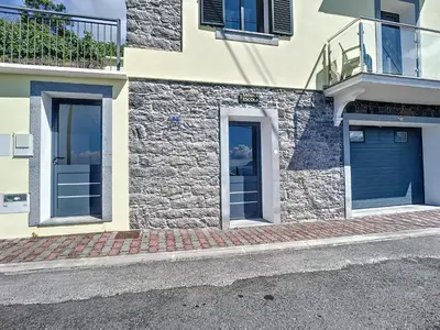 a building with two blue garage doors on it at My School I by Atlantic Holiday in Ponta Delgada