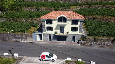 a white van parked in front of a house at My school II by Atlantic Holiday in Ponta Delgada