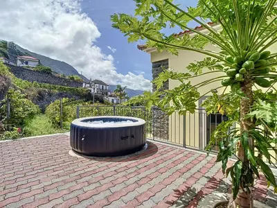 a hot tub sitting on top of a brick patio at My school II by Atlantic Holiday in Ponta Delgada