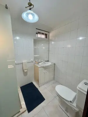 a bathroom with a toilet and a sink and a mirror at Casa Carneirinho by Olá Madeira in Paul do Mar