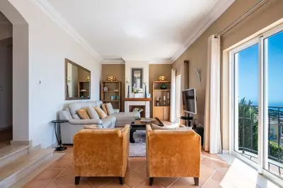 a living room with a couch and chairs at Balancal Apartments and Villas Palheiro Village by Holiday Rental Madeira in Funchal