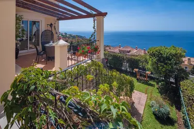 a balcony of a house with a view of the ocean at Balancal Apartments and Villas Palheiro Village by Holiday Rental Madeira in Funchal