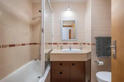 a bathroom with a sink and a tub and a toilet at Ocean view Madeira in Caniço