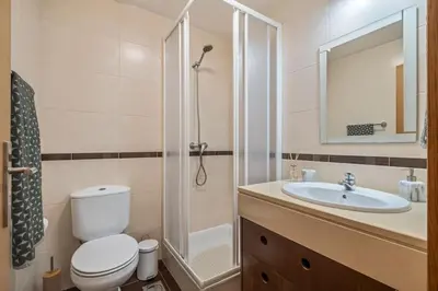 a bathroom with a toilet and a sink and a shower at Ocean view Madeira in Caniço