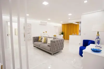 a living room with a couch and a blue chair at Pérola dos Anjos by LovelyStay in Funchal