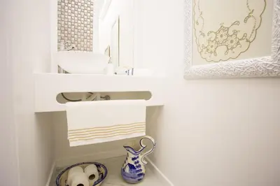 a bathroom with a sink and a blue and white vase at Pérola dos Anjos by LovelyStay in Funchal